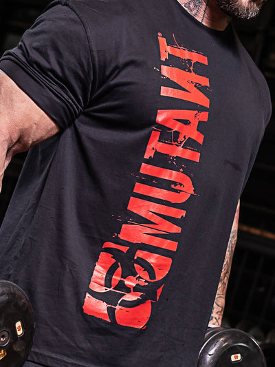 Close-up of the vertical Mutant red logo applied on the black Free Standing Oversized Gym T-Shirt.