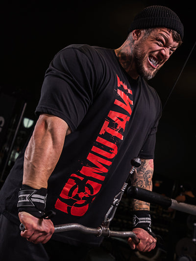 Jamie Christian, Mutant athlete, training in the gym wearing the Black Free Standing Oversized Gym T-Shirt featuring a vertical Mutant red logo.